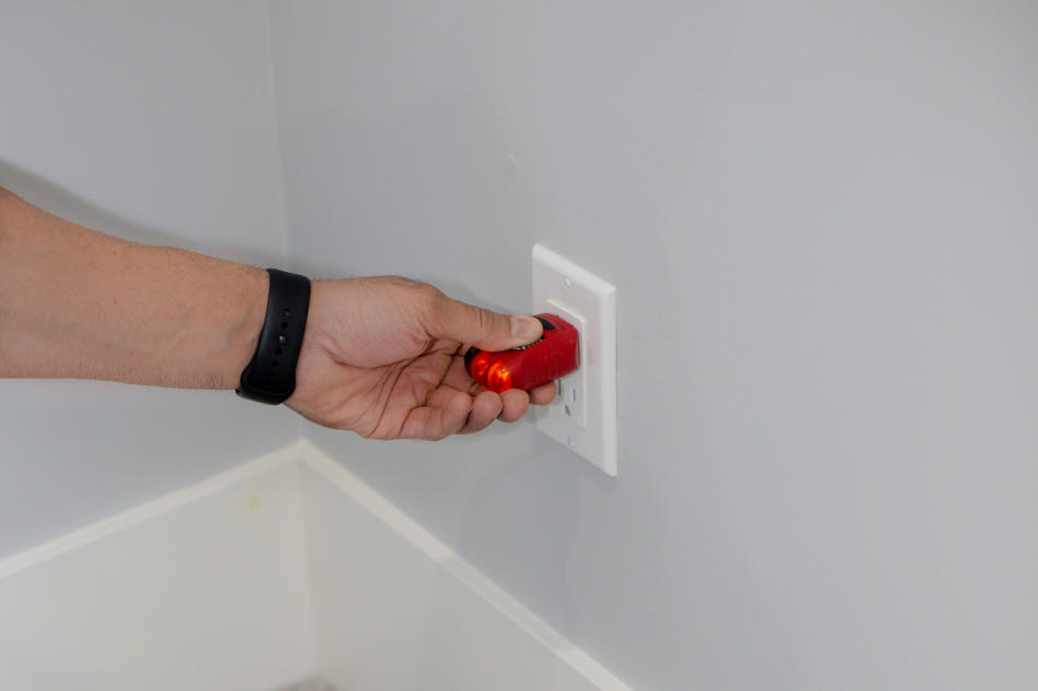 Home inspector checking outlet